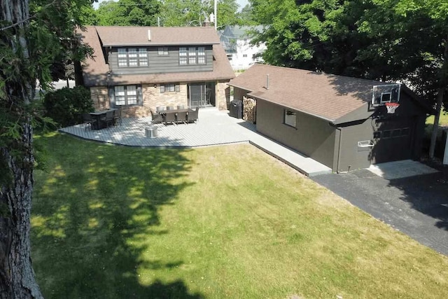 back of house with a lawn and a patio area