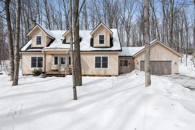 new england style home with an attached garage