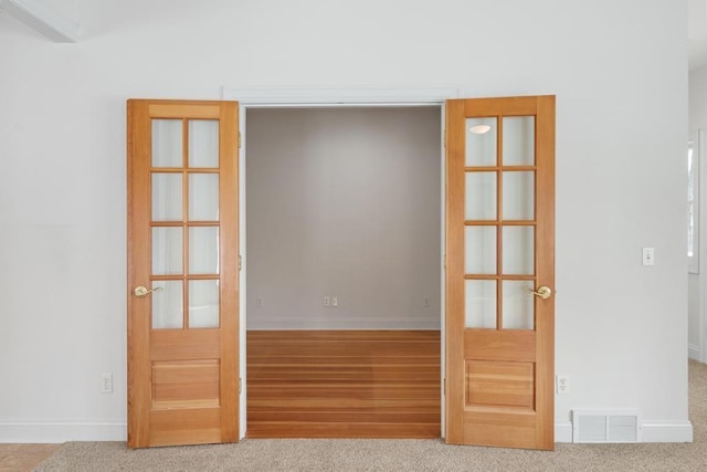 interior space with carpet floors, baseboards, and visible vents