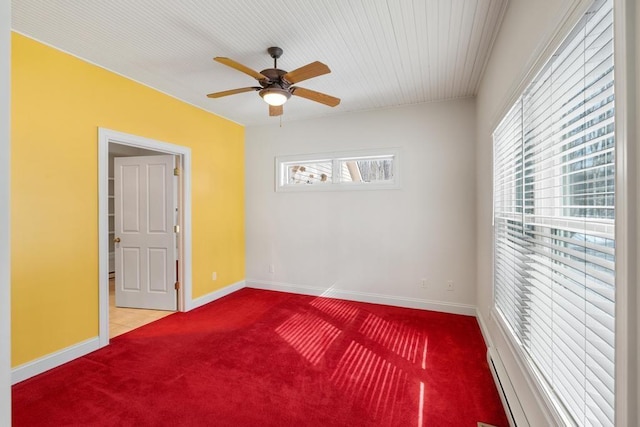 carpeted empty room featuring baseboards and a ceiling fan