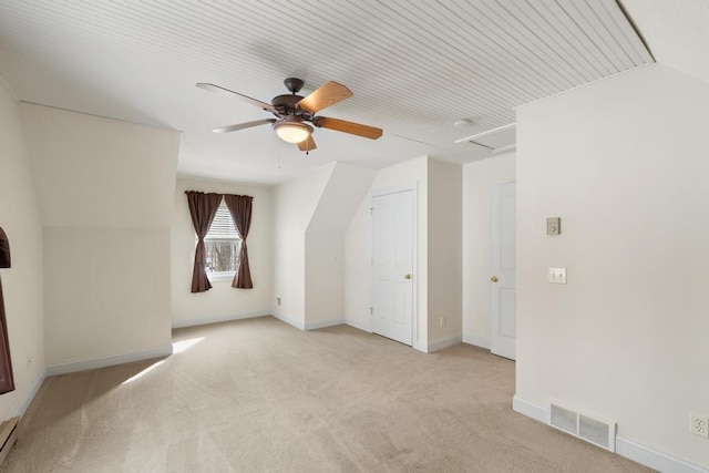 bonus room with baseboards, visible vents, light colored carpet, a baseboard radiator, and ceiling fan