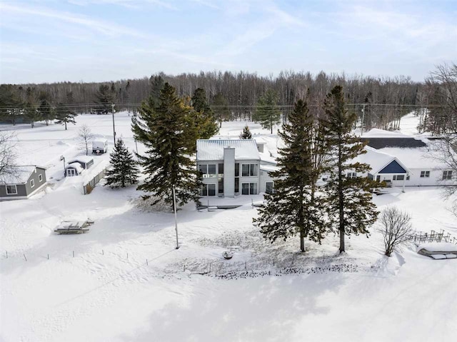 snowy aerial view featuring a view of trees