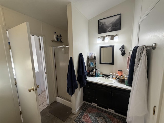 full bath with lofted ceiling, a stall shower, and vanity