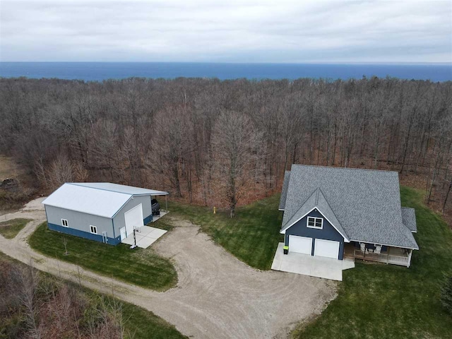 birds eye view of property featuring a view of trees