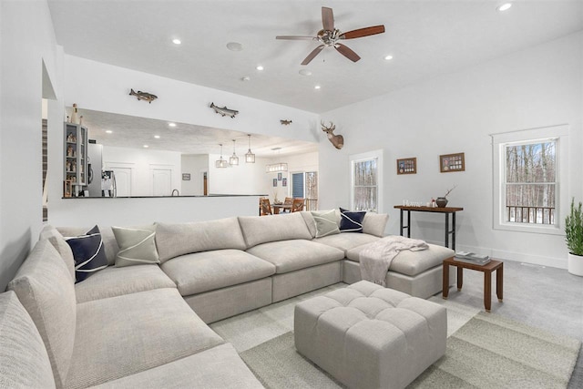 living room with ceiling fan, baseboards, and recessed lighting