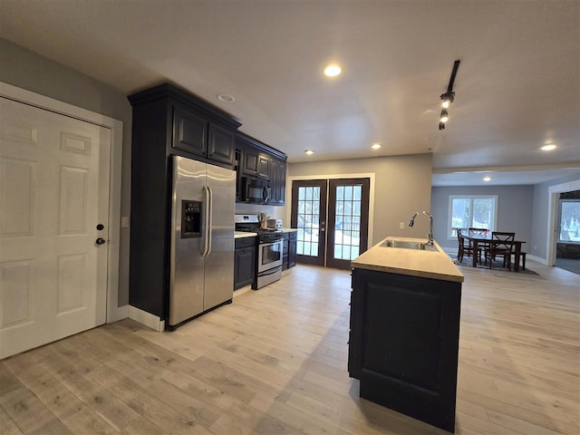 kitchen with french doors, a sink, recessed lighting, and appliances with stainless steel finishes