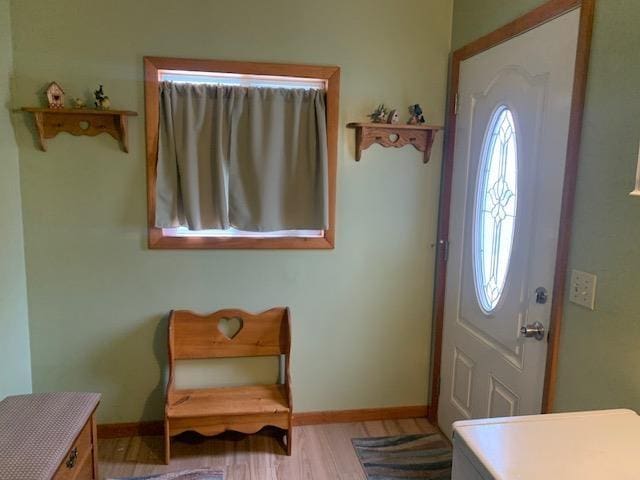 foyer entrance featuring light wood-type flooring and baseboards