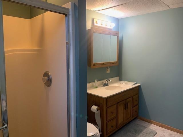 full bath with toilet, baseboards, walk in shower, and vanity