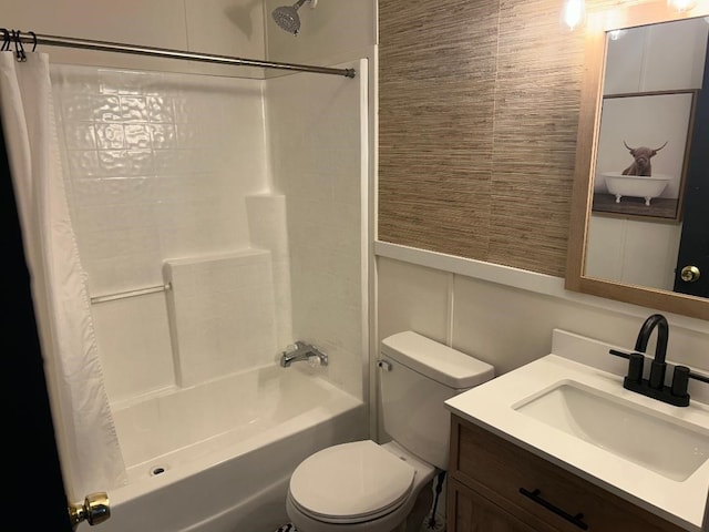 full bathroom with wainscoting, vanity, toilet, and shower / bath combo with shower curtain