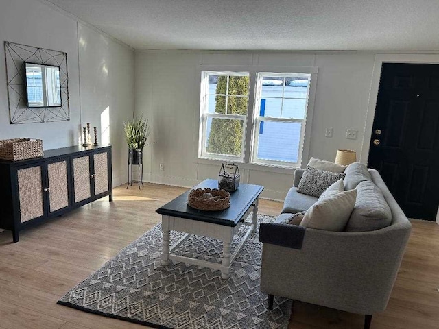 living area with a textured ceiling and light wood-style floors