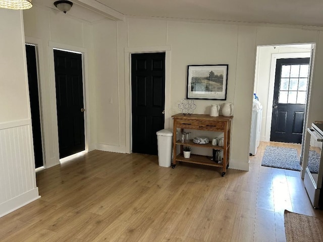 entrance foyer with a decorative wall and light wood finished floors