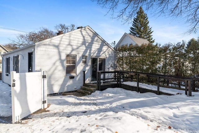 view of front facade featuring a wooden deck and fence