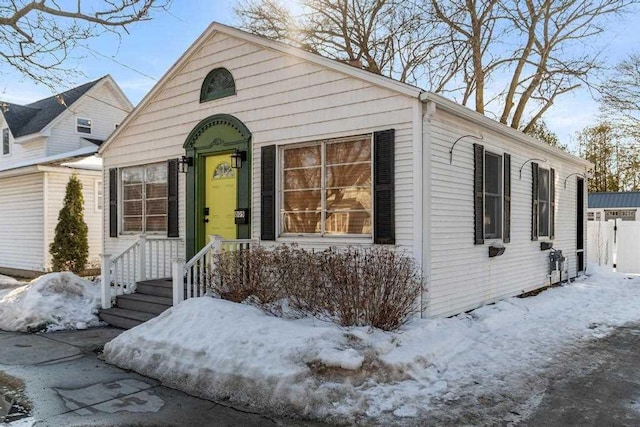 bungalow-style home with fence