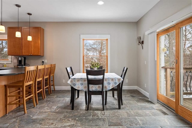 dining area with stone finish flooring, recessed lighting, visible vents, and baseboards