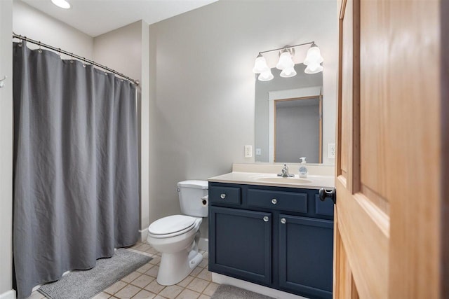 bathroom with tile patterned flooring, a shower with shower curtain, vanity, and toilet