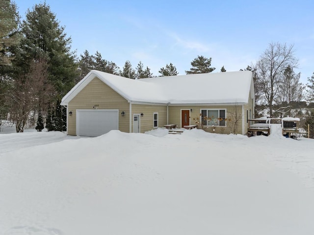 ranch-style home featuring an attached garage and a wooden deck