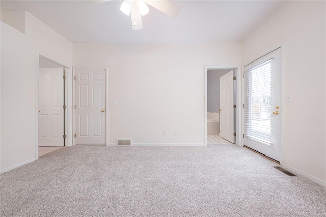 unfurnished room with visible vents, light carpet, and baseboards