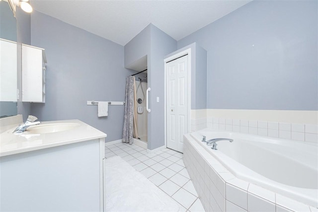 bathroom featuring vanity, baseboards, a shower stall, a bath, and tile patterned floors