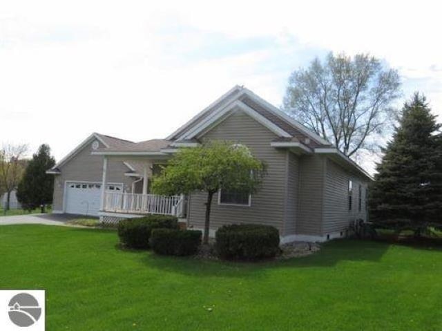 view of side of property with a garage and a yard