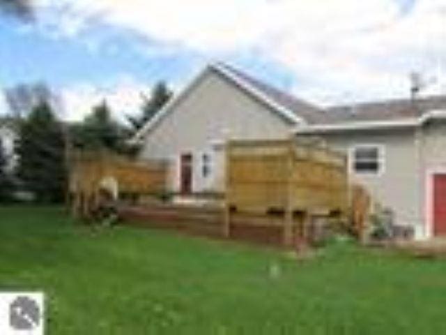 rear view of house featuring a yard