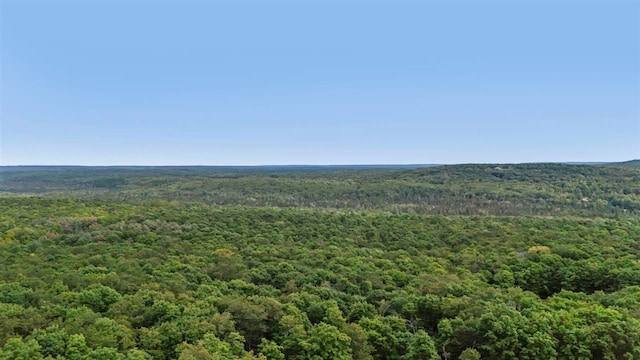 birds eye view of property featuring a view of trees