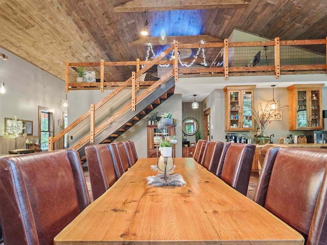 dining room with wood ceiling, stairs, high vaulted ceiling, and bar area