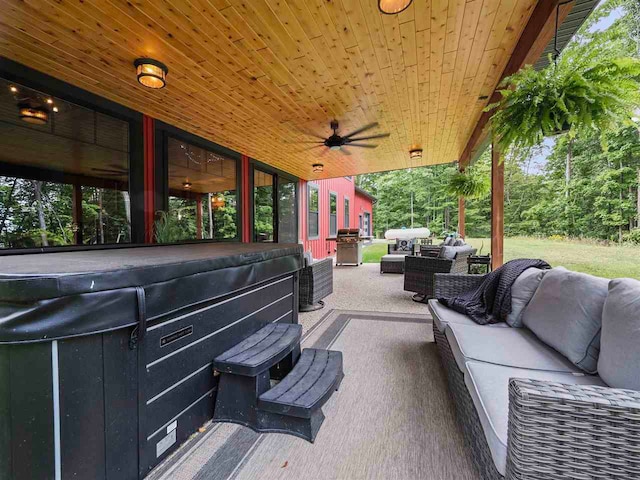 view of patio / terrace with ceiling fan, grilling area, an outdoor living space, and a hot tub