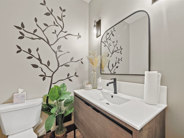 bathroom featuring toilet and vanity