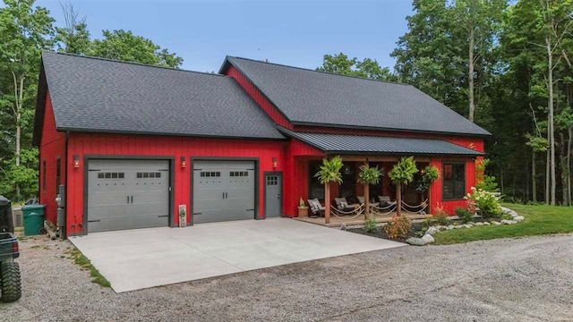 view of front of property with a shingled roof and concrete driveway