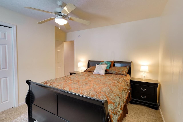 bedroom featuring light colored carpet, ceiling fan, and baseboards