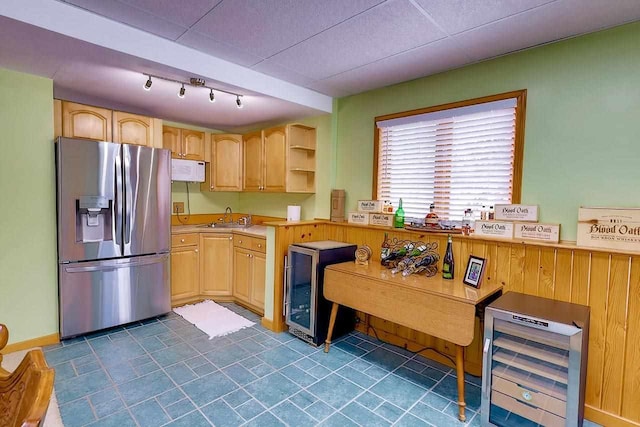 kitchen with wine cooler, stainless steel refrigerator with ice dispenser, light countertops, light brown cabinetry, and a sink