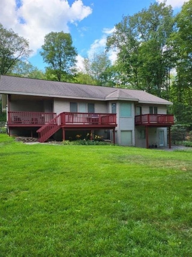 back of property with a lawn and a deck