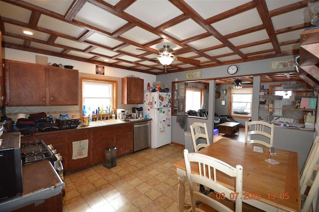 kitchen with a sink, a ceiling fan, stainless steel dishwasher, and freestanding refrigerator