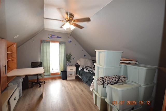 bedroom featuring vaulted ceiling, light wood-style flooring, and a ceiling fan