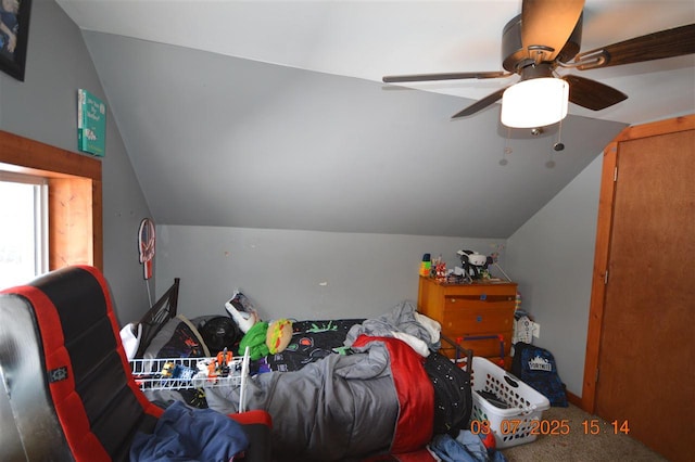 bedroom with a ceiling fan, lofted ceiling, and carpet