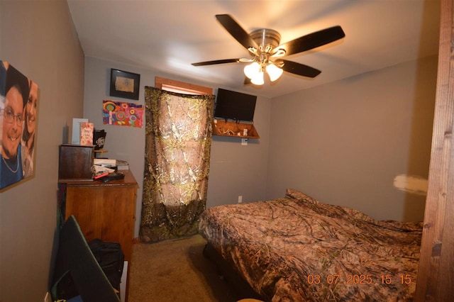 bedroom with a ceiling fan and carpet
