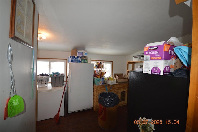 kitchen with visible vents, wood finished floors, and freestanding refrigerator