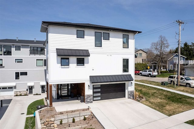 view of front of house with driveway, metal roof, and a standing seam roof