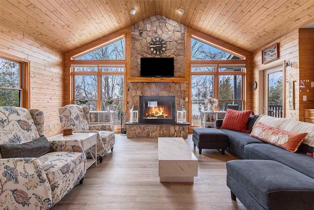 living room with wood ceiling, wooden walls, and a healthy amount of sunlight