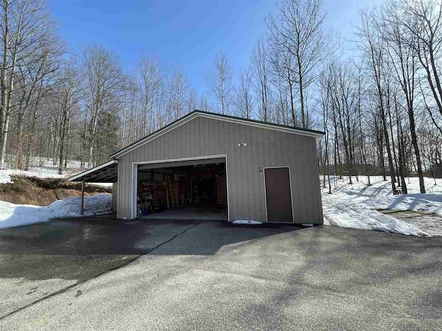 snow covered garage with a garage