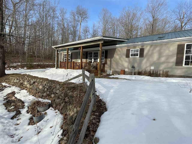 exterior space featuring covered porch and metal roof