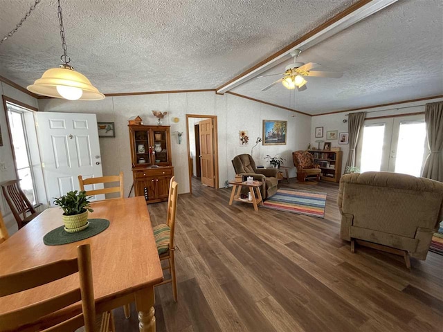 dining room with vaulted ceiling with beams, wood finished floors, french doors, and a textured ceiling