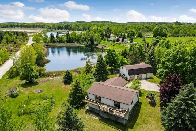 drone / aerial view with a view of trees and a water view