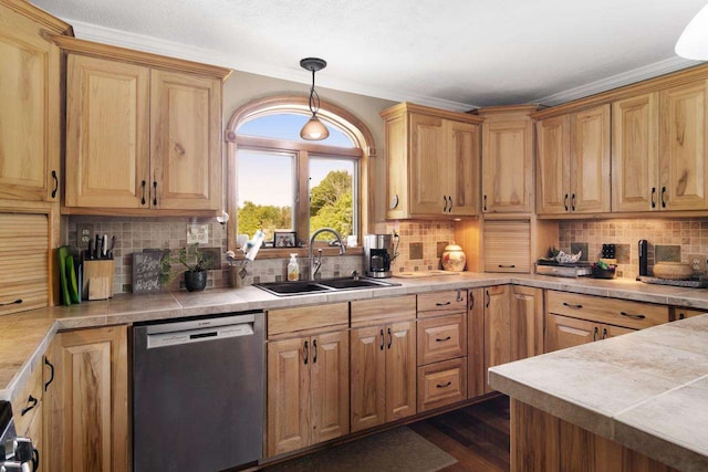 kitchen featuring dark wood finished floors, a sink, decorative backsplash, dishwasher, and crown molding