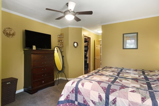 bedroom with a ceiling fan, carpet, baseboards, ornamental molding, and a spacious closet