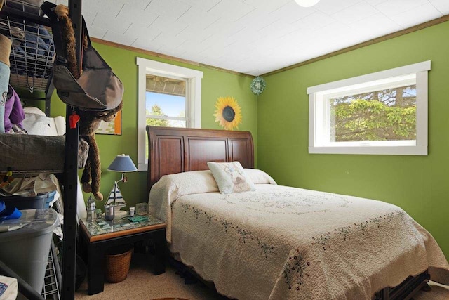 bedroom featuring crown molding, multiple windows, and carpet