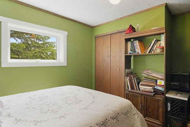 bedroom with a closet and crown molding