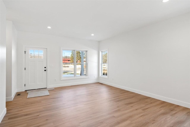 foyer entrance with recessed lighting and light wood-style flooring