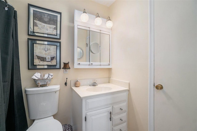 bathroom featuring toilet and vanity