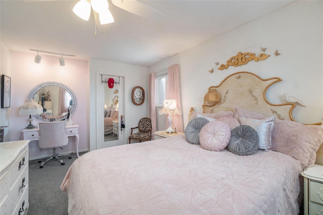 bedroom with track lighting and carpet flooring